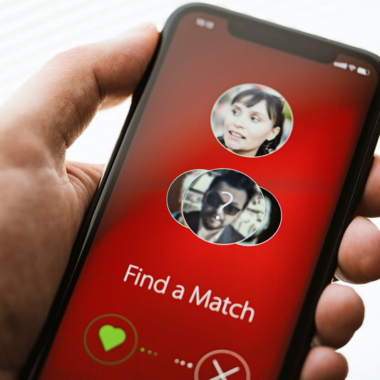 Hand holding mobile phone with dating app. Swipe through potential matches. Find love online with mobile dating apps.