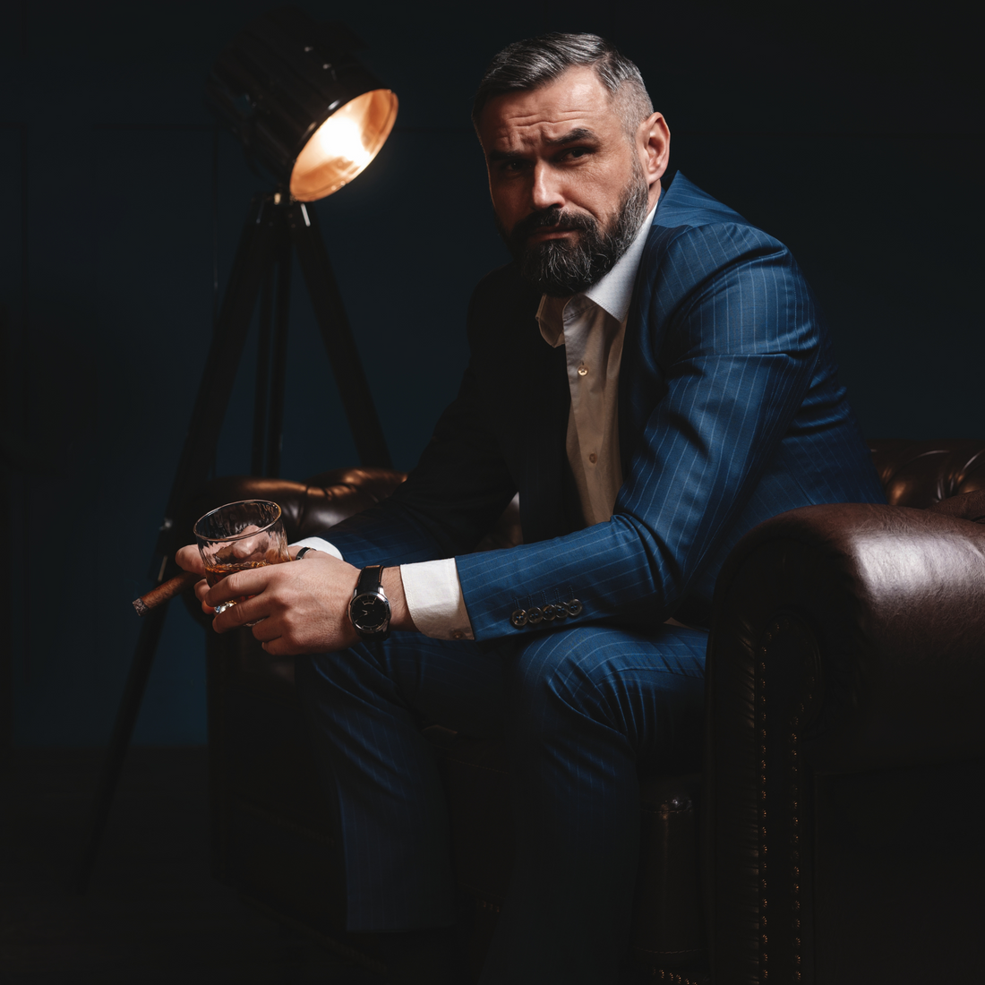 Suit drinking male sitting sofa cigar whiskey glass