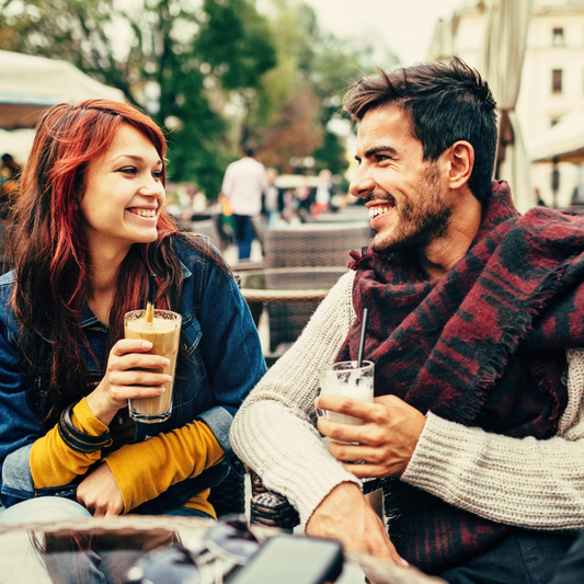 woman man couple outside drinking cafe coffee juice cocktail dressed table phone