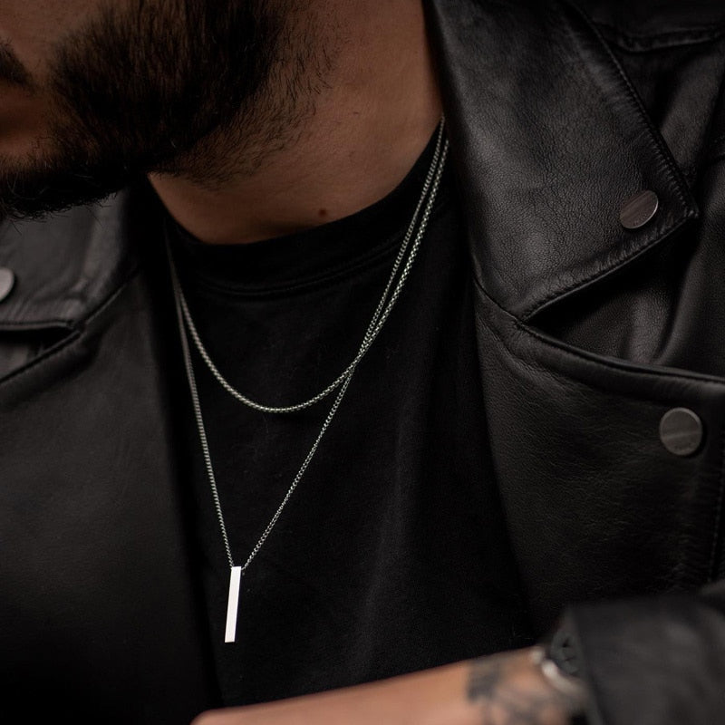 Man Leather Jacket wearing silver necklace chain pendant which helps with attraction and style